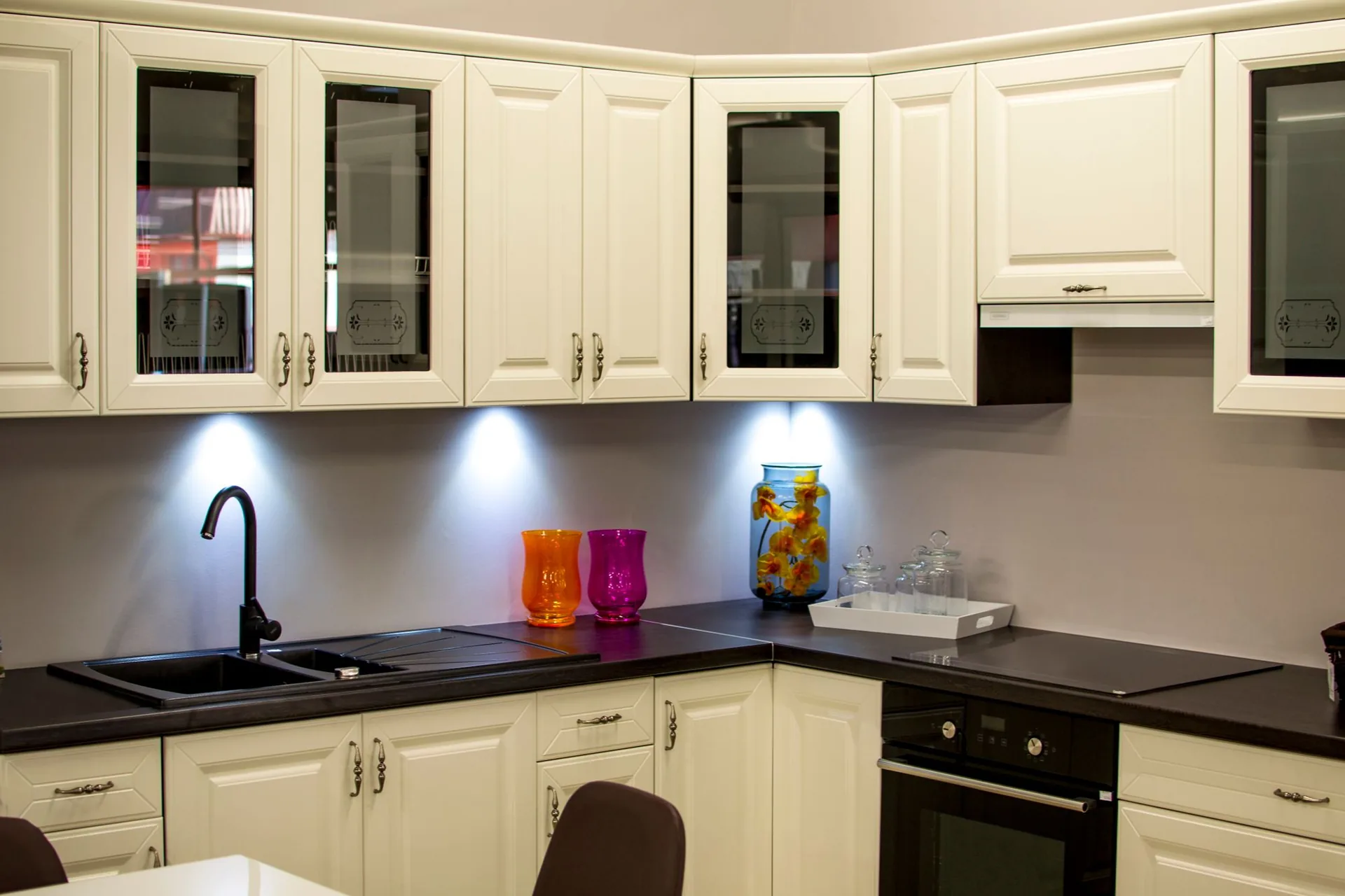 Kitchen with refinished cream cabinets and under-cabinet lighting