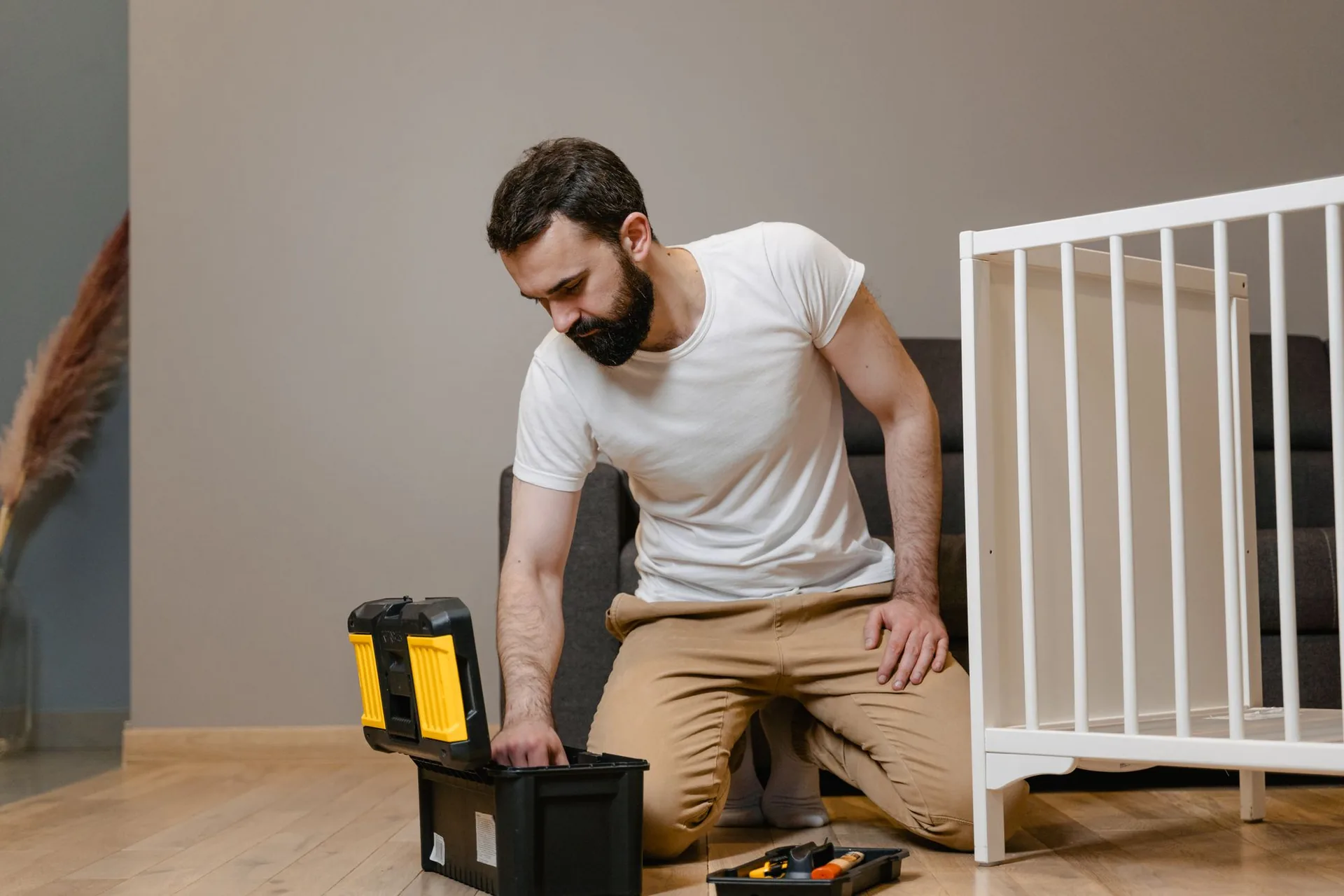 Handyman opening a toolbox in a home